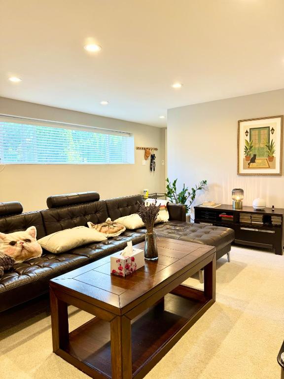 a living room with a couch and a coffee table at Ivy s House in West Vancouver