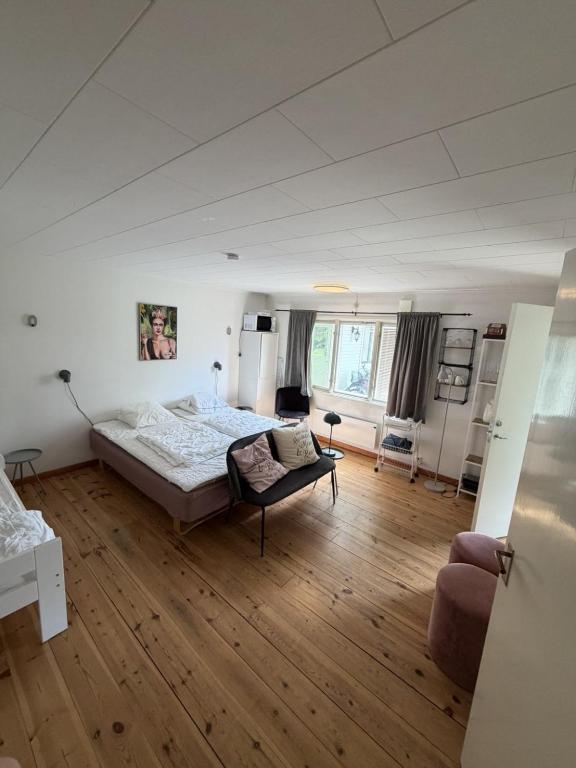 a large bedroom with a bed and a couch at SleepCleanGo L3 in Gnisvärd