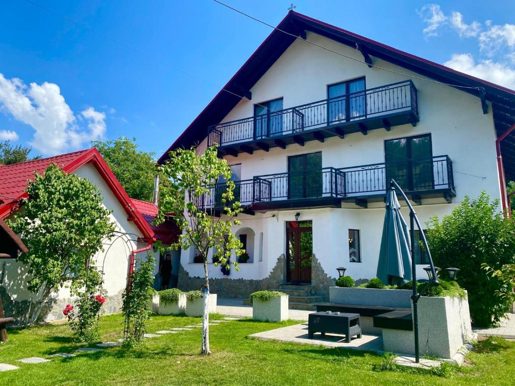 a white house with a red roof at Balkanic Villa Bran in Bran