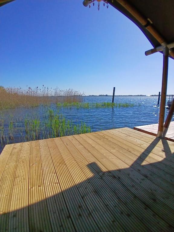 a dock with a view of a body of water at Safaritent 4 in Biddinghuizen