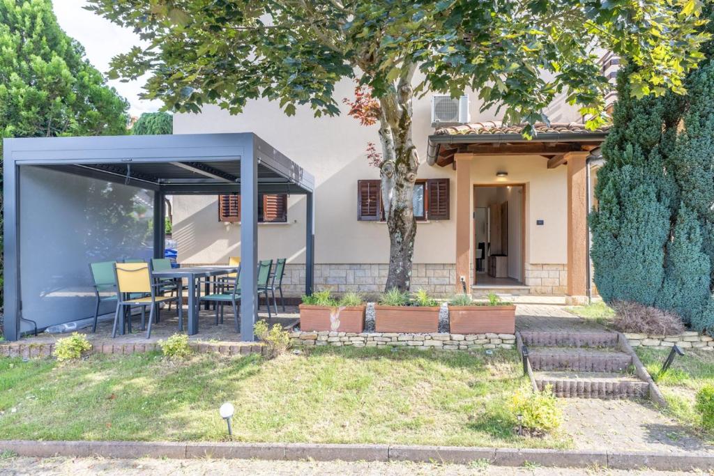 a house with a blue roof at Green Oasis with Terrace in Pazin