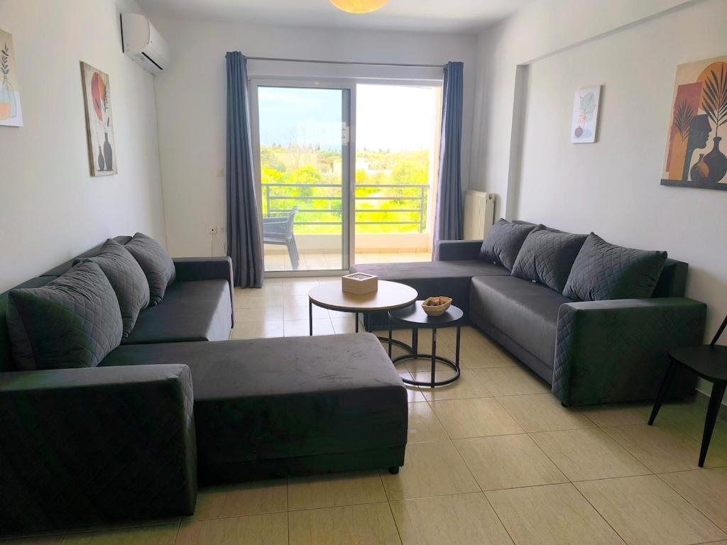 a living room with a couch and a table at Tranquil central apartment in Ampavris
