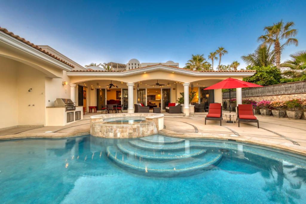 a home with a swimming pool and a house at Casa 4 C's in Cabo San Lucas
