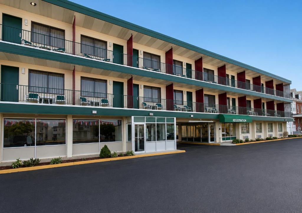 an apartment building with balconies and a parking lot at Lincoln Way Inn in Chambersburg