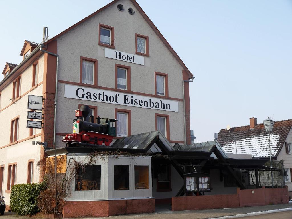 a building with a sign that reads casoit eiseneland at Hotel-Gasthof-Destille-Eisenbahn in Mosbach