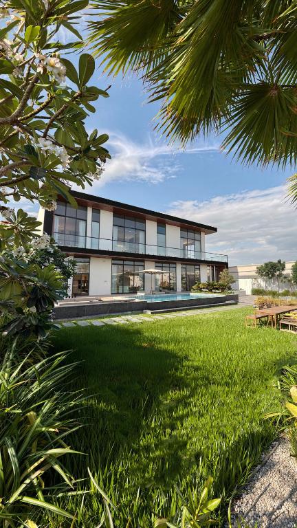 a building with a green lawn in front of it at Villa 72 RAK in Ras al Khaimah