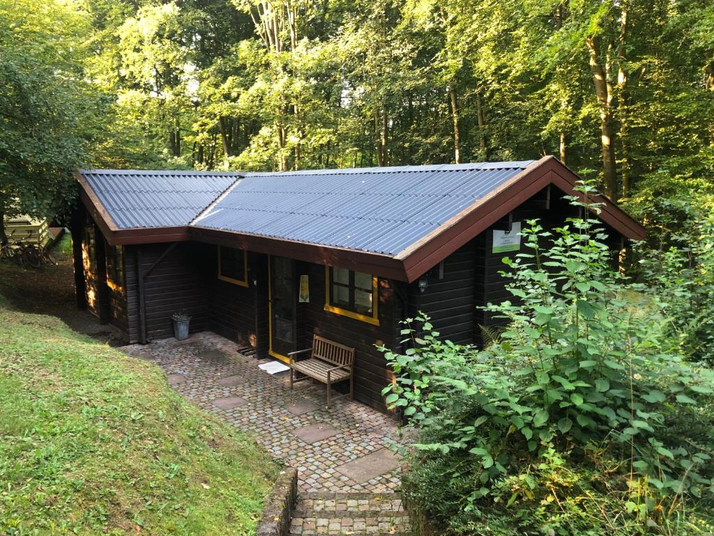 a cabin in the woods with a solar roof at Kleine Auszeit am Twistesee in Bad Arolsen