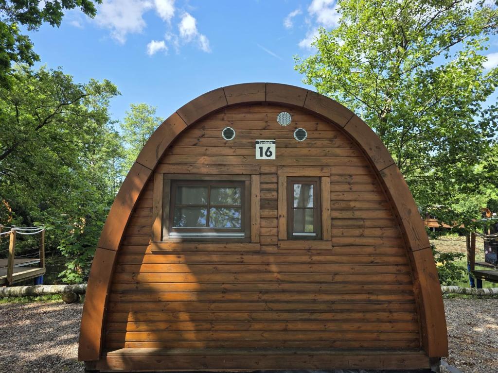 a large wooden cabin with a window in the front at 16 Premium Camping Pod "Bornholm" in Silberstedt