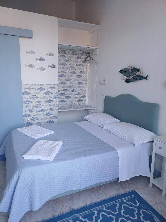 a bedroom with a bed with white sheets and a window at Le Stanze del Mare - B&B in Messina