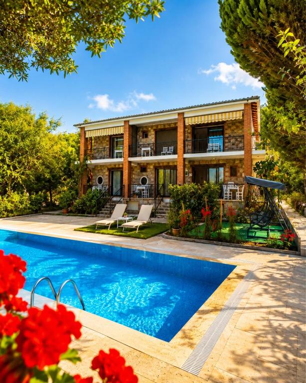 an exterior view of a house with a swimming pool at Doğa Pansiyon in Marmaris