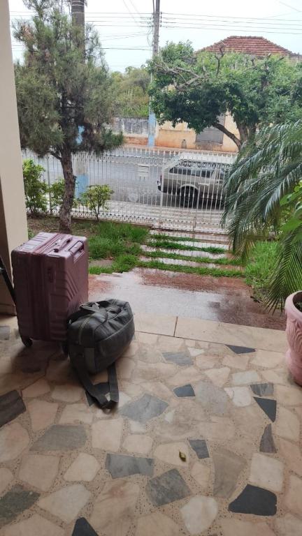 a suitcase sitting on the ground next to at POUSADA ELSHADAY Centro in Osvaldo Cruz