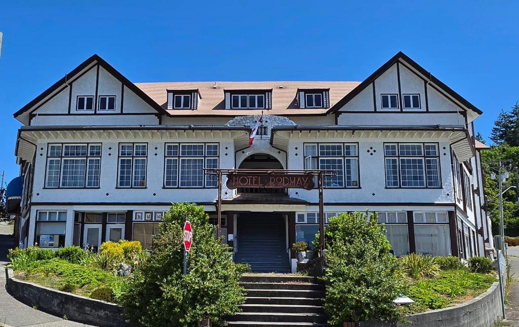 a large house with a street sign in front of it at Rodmay Heritage Hotel in Powell River