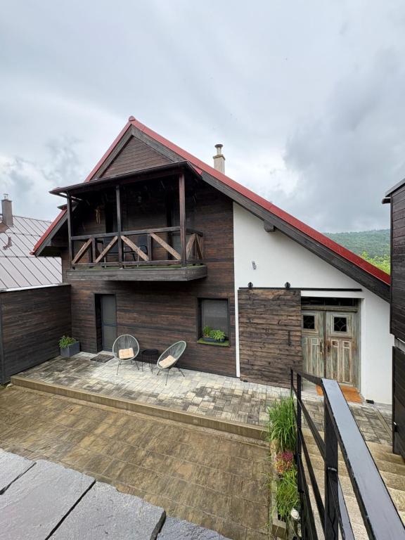 a house with two chairs on a patio at Chata Snowee Valča in Stará Turá