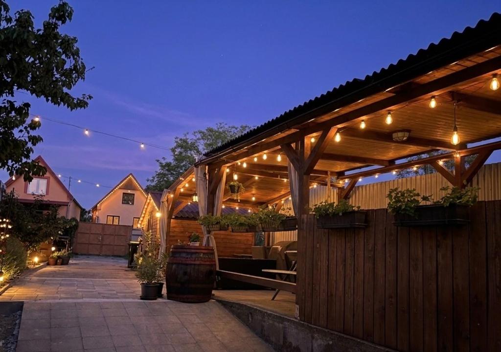 a pergola with lights on a patio at night at ZAPOMENUTÝ SKLÍPEK in Olbramovice
