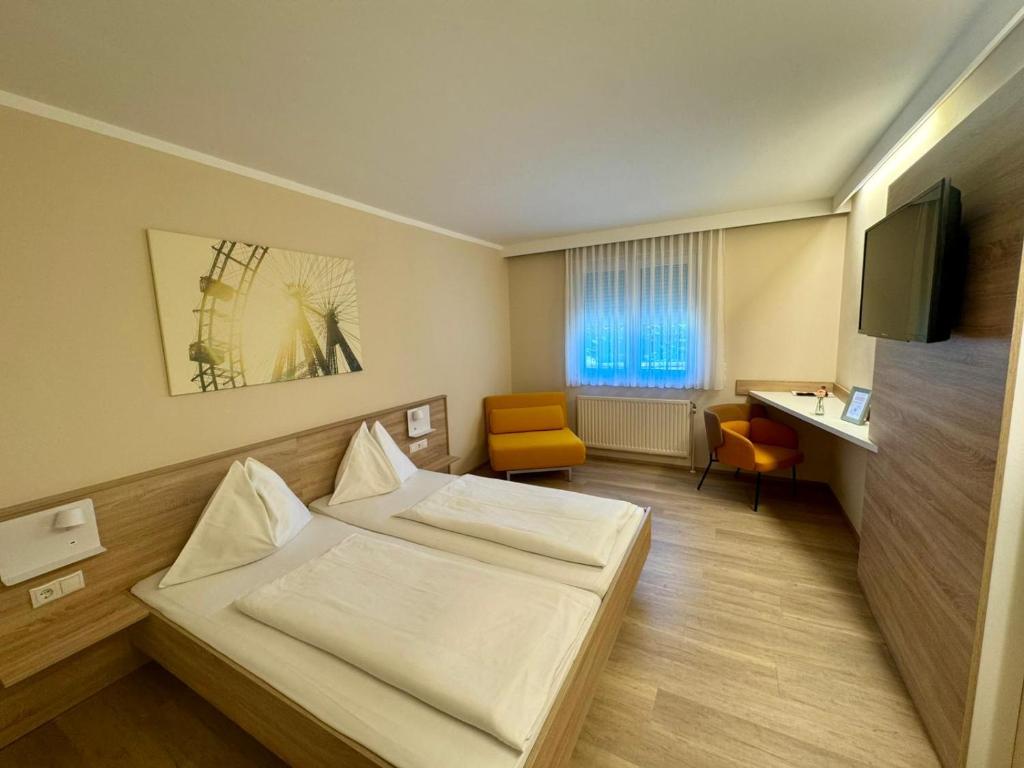 a hotel room with a bed and a desk at Pension Weber in Vienna
