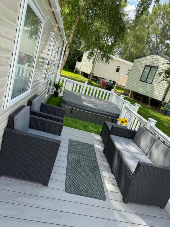 a patio with wicker furniture on a house at Tattershall Lakes 49 Larch View in Tattershall
