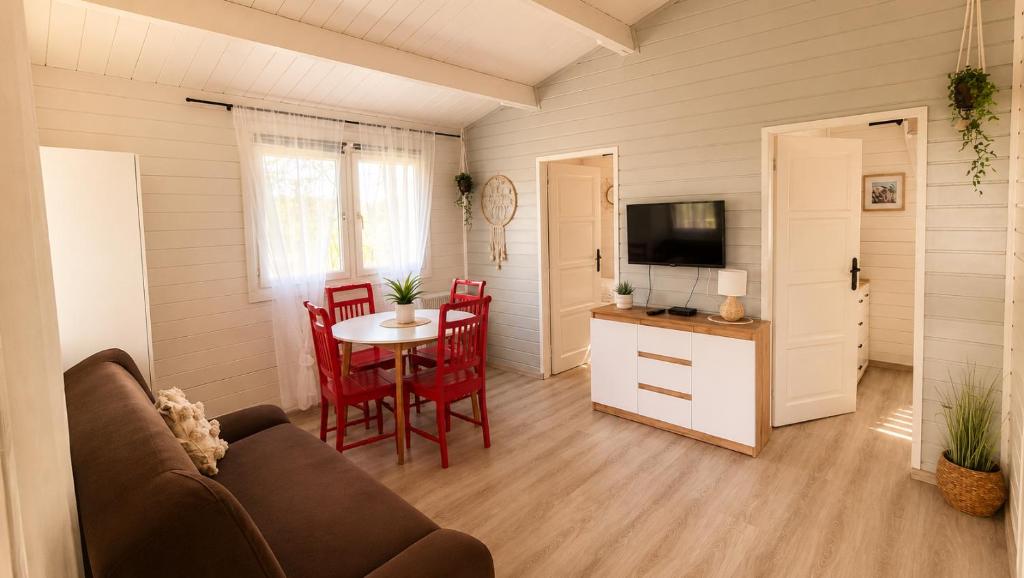 a living room with a couch and a table at Domek ASIA in Wronka