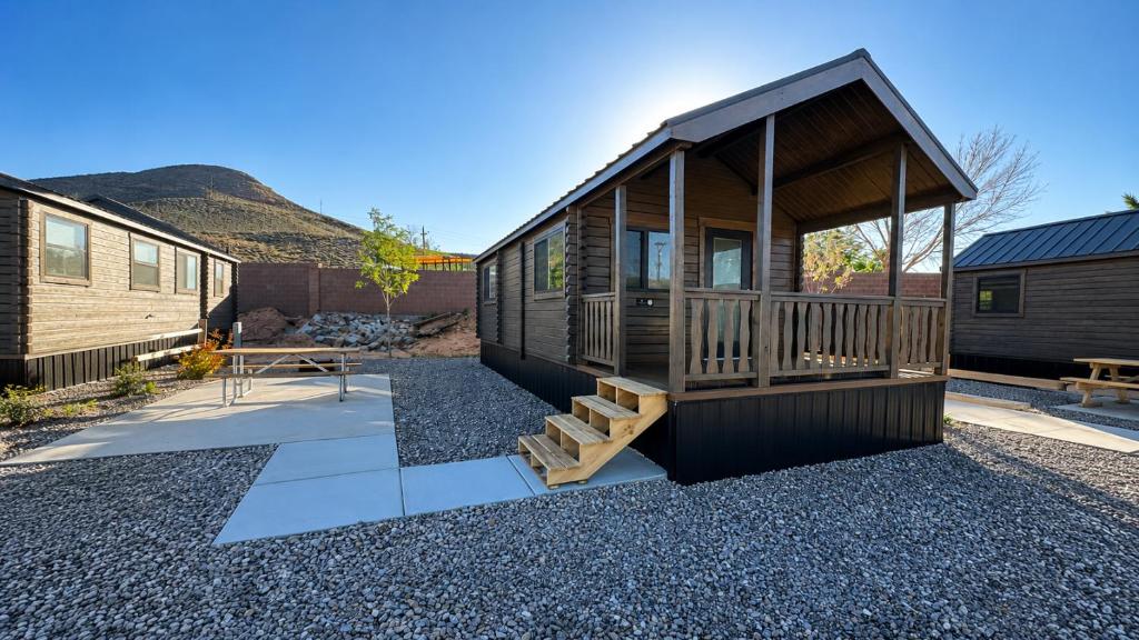 a small cabin with a porch and a picnic table at Zion Vacation Cabins in Virgin