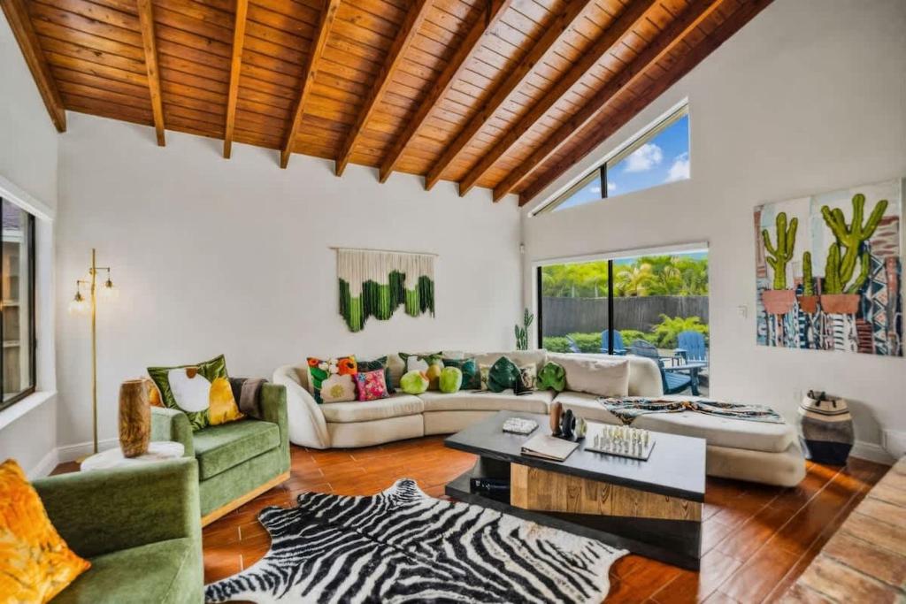 a living room with a zebra patterned rug at Pool - BBQ - Fire pit - Pool Table - TV room in Miami