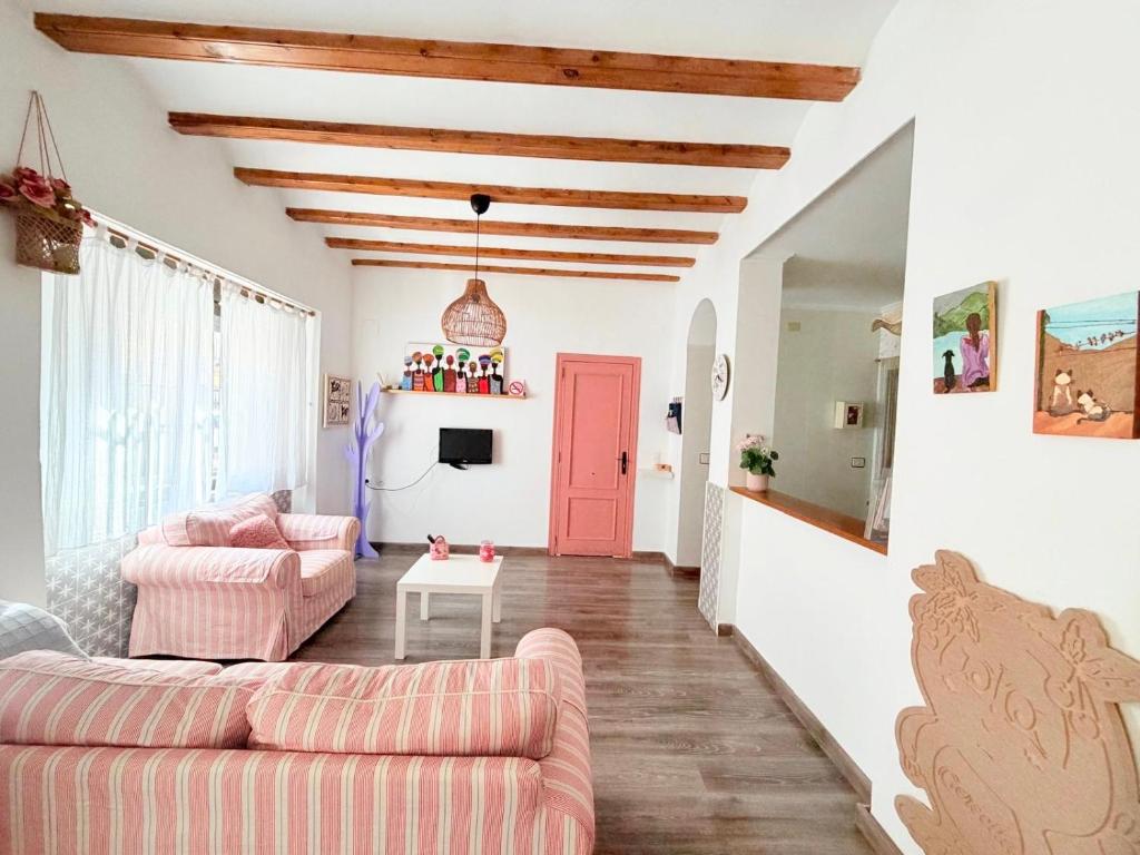 a living room with two couches and a pink door at Villabett Caudiel está de moda in Caudiel