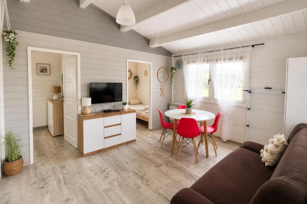 a living room with a couch and a table at Domek LENA in Giżycko