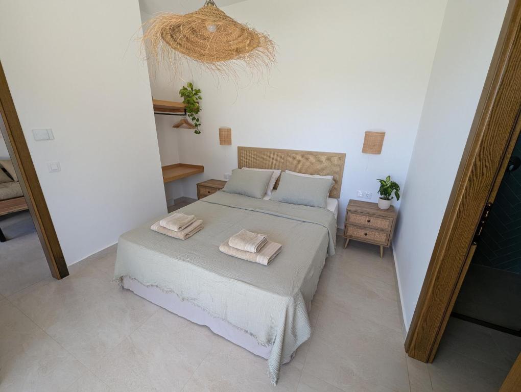 a bedroom with a bed with two towels on it at Guesthouse Morito in Ierissos
