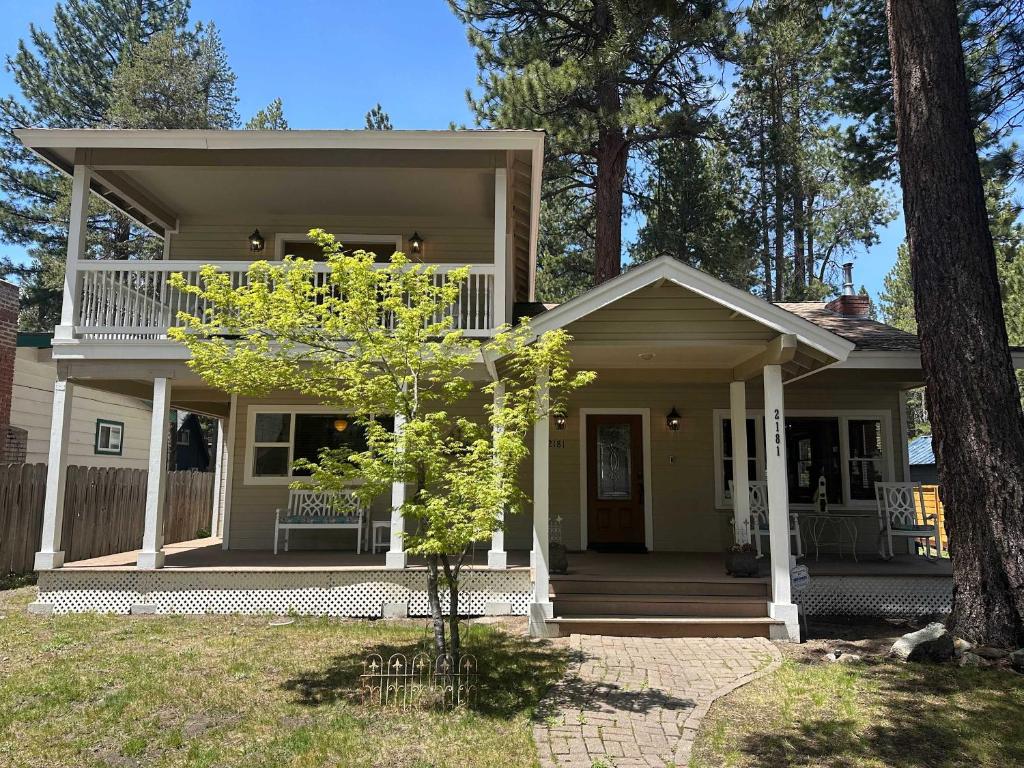 a small house with a porch and a tree at Royal Retreat Quiet & Cozy in South Lake Tahoe