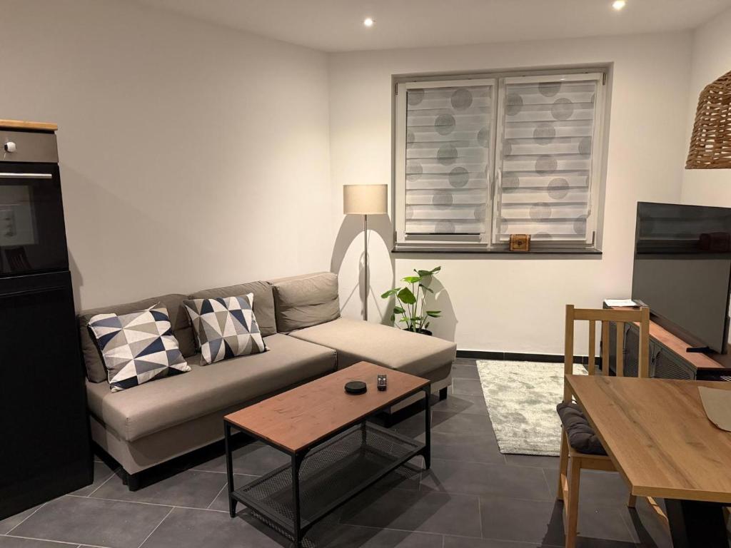 a living room with a couch and a table at RS home CB 1 in Cottbus