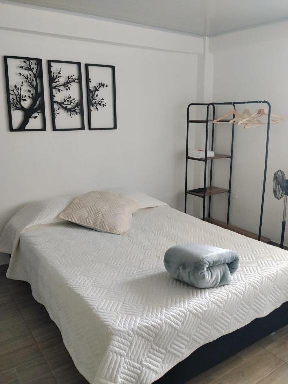 a white bed with a towel on top of it at Apartaestudios Santa Ana in Ruiosucio