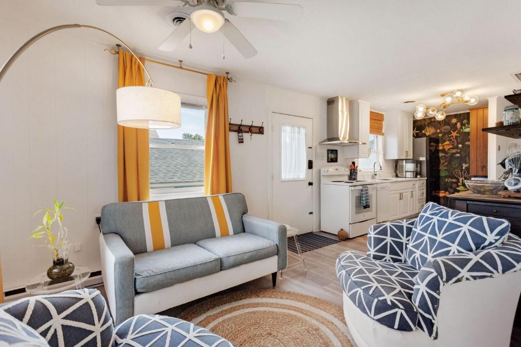 a living room with a couch and a kitchen at 5041 - The Captains Quarters in Kill Devil Hills
