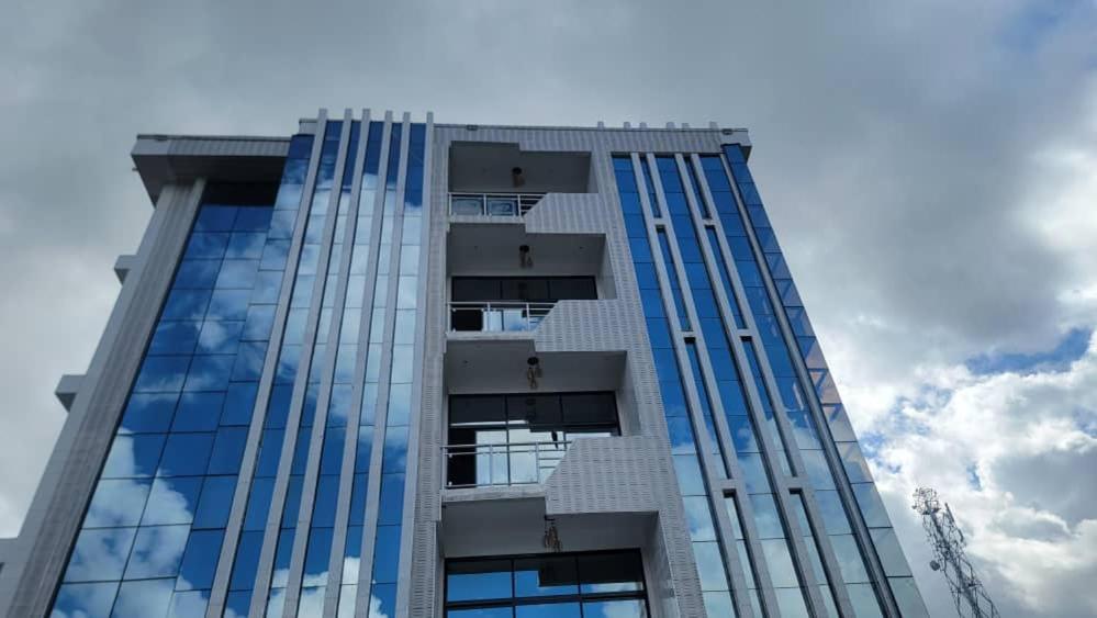 a tall building with glass windows on the side of it at Wete View Hotel in Wete