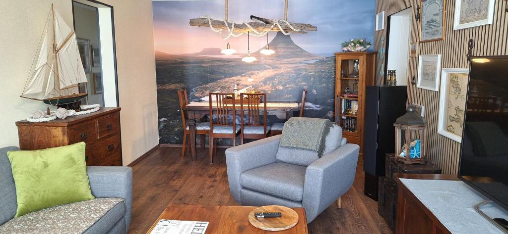 a living room with a painting on the wall at Windy Guesthause in Grundarfjordur
