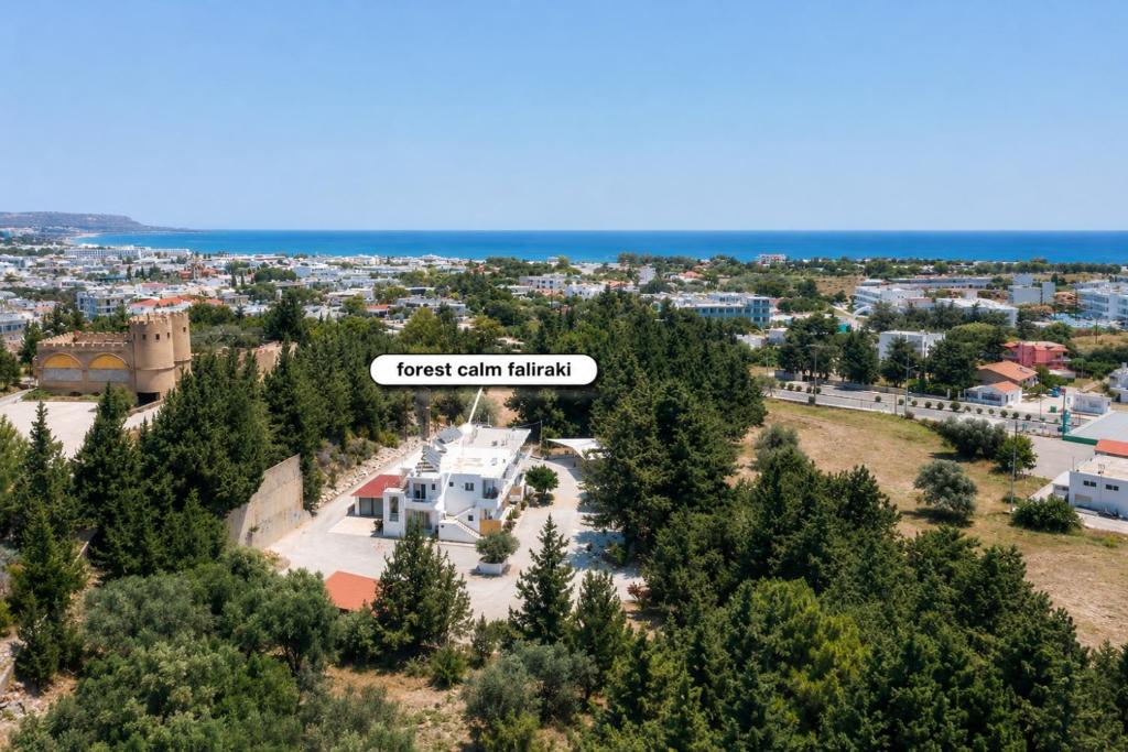 an aerial view of a city with a sign that reads forest city church at Forest Calm Faliraki in Faliraki
