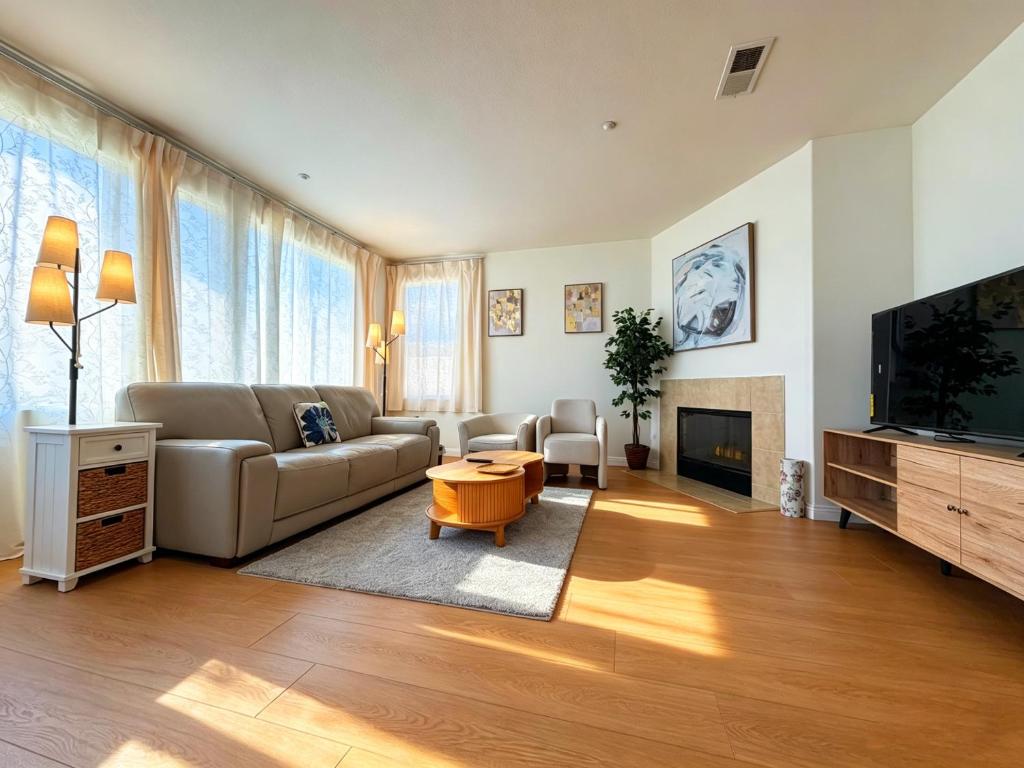 a living room with a couch and a tv at Spacious Private Bedrooms With Full Amenities Near Grocery Stores & Main Highway Routes in Fontana