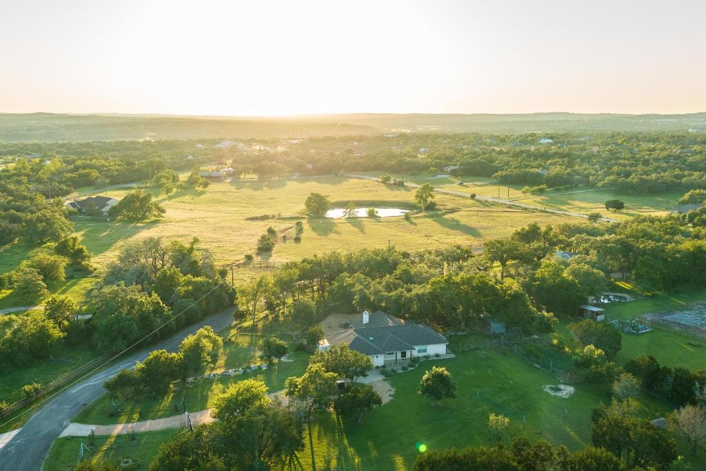 an aerial view of a house in a field at Private Luxury Getaway | Fire Pit | Near Weddings in Dripping Springs