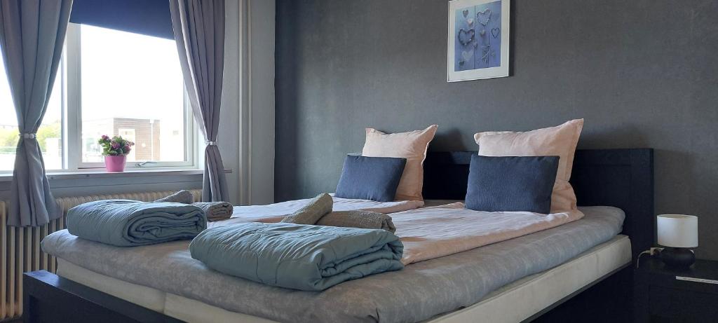 a bed with pillows on it in a bedroom at Venos rooms in Hirtshals