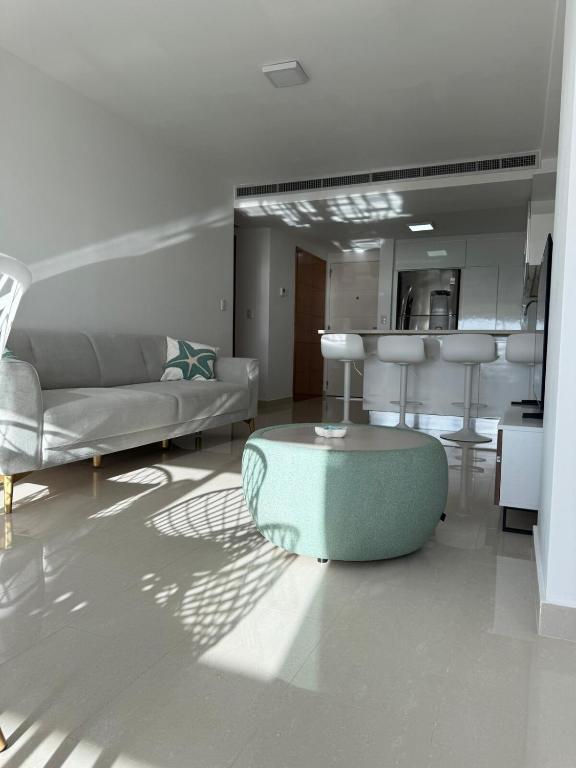 a living room with a couch and a table at Apartamento en Pampatar in Pampatar