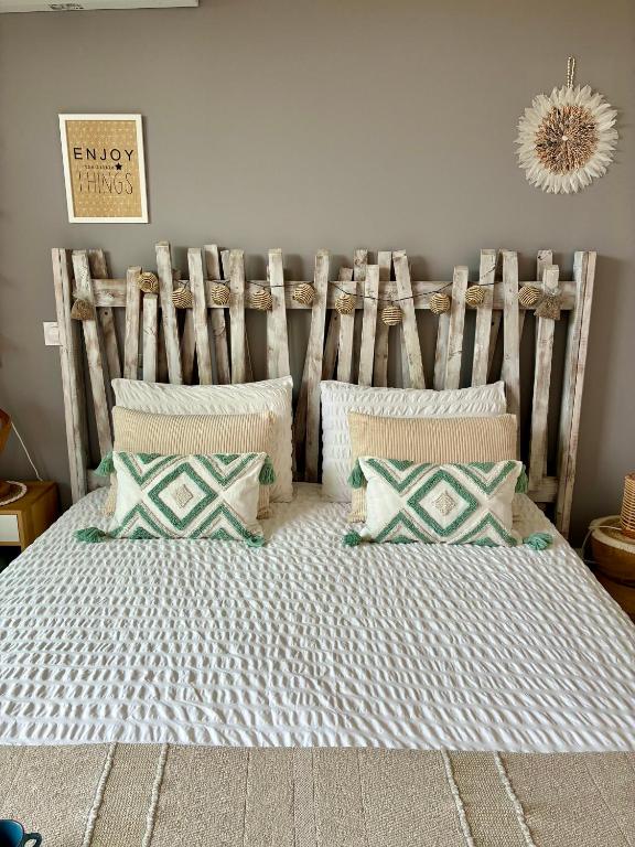 a bedroom with a large bed with pillows at Studios Nuitée en Provence in Aix-en-Provence