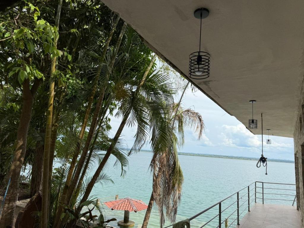 a view of the water from a beach with an umbrella at Del Mar Beach House in Nimá