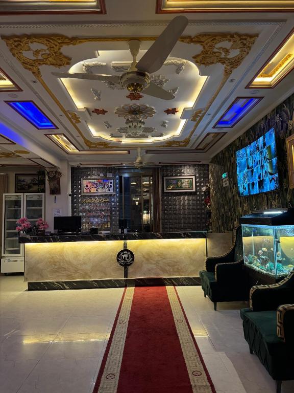 a lobby with a bar and a fish tank at Taj luxury hotel Quetta in Quetta