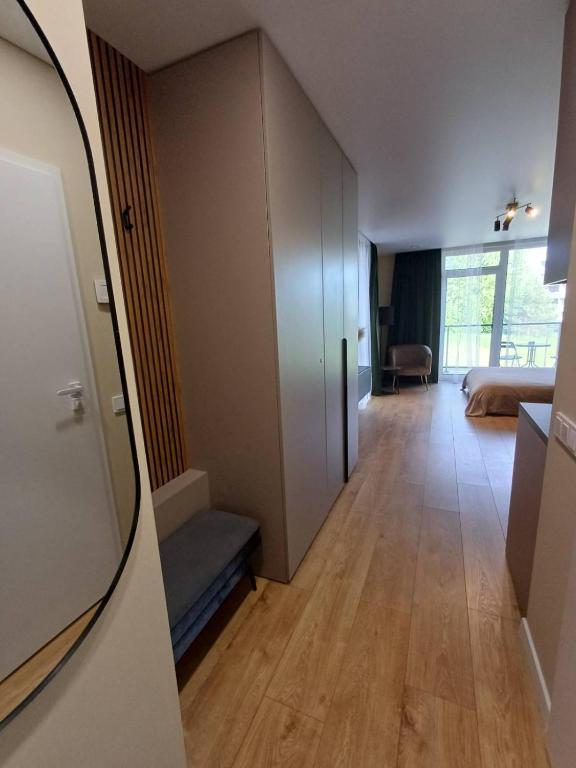 a hallway leading to a room with a bedroom at Labaresto Plaza jums in Vilnius
