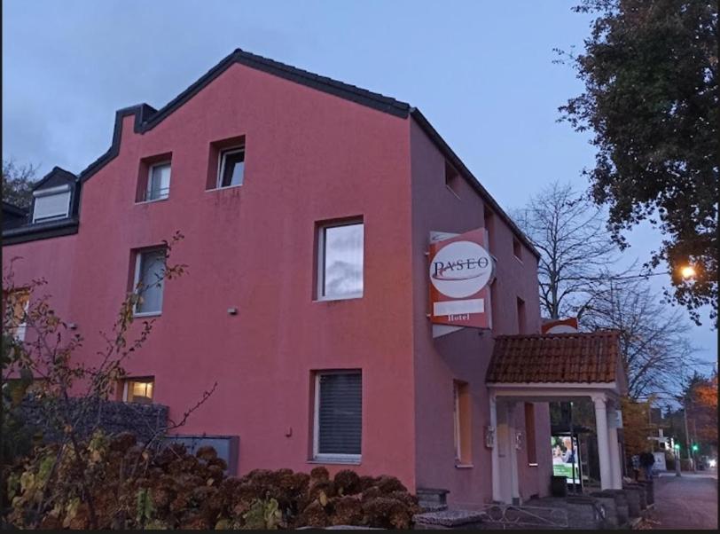 a pink building with a sign on the side of it at Campus Hotel - ehemals Hotel Paseo in Aachen