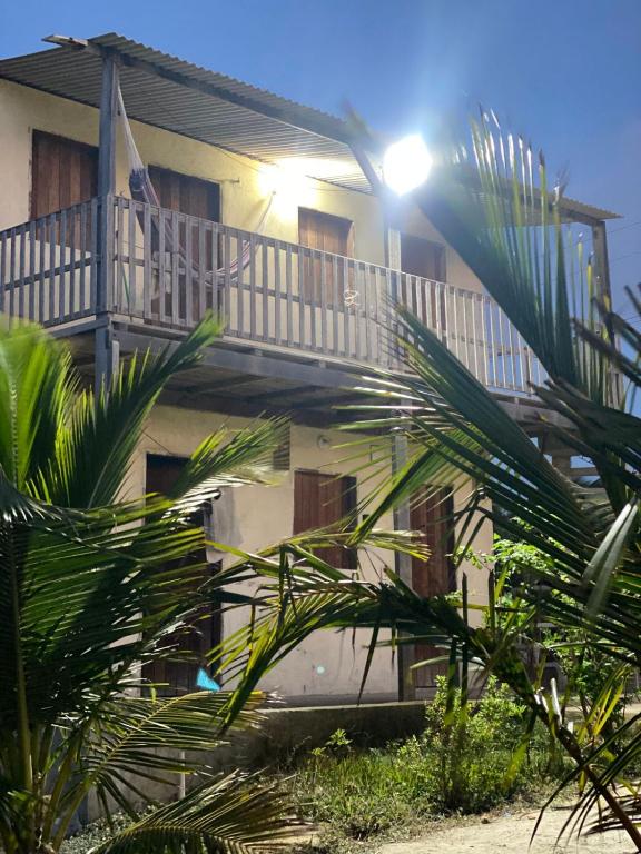 a building with a balcony with a light on it at Pousada degamix in Barroquinha