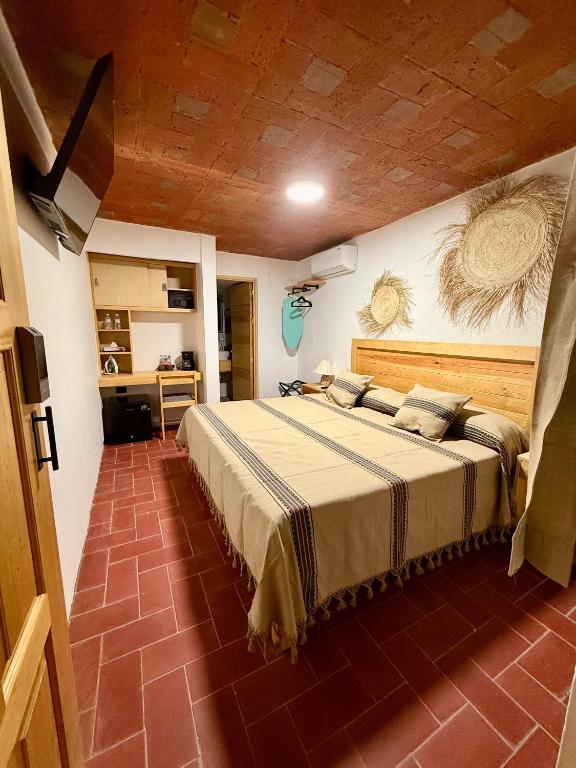 a bedroom with a large bed in a room at Casa Agaves in Oaxaca City