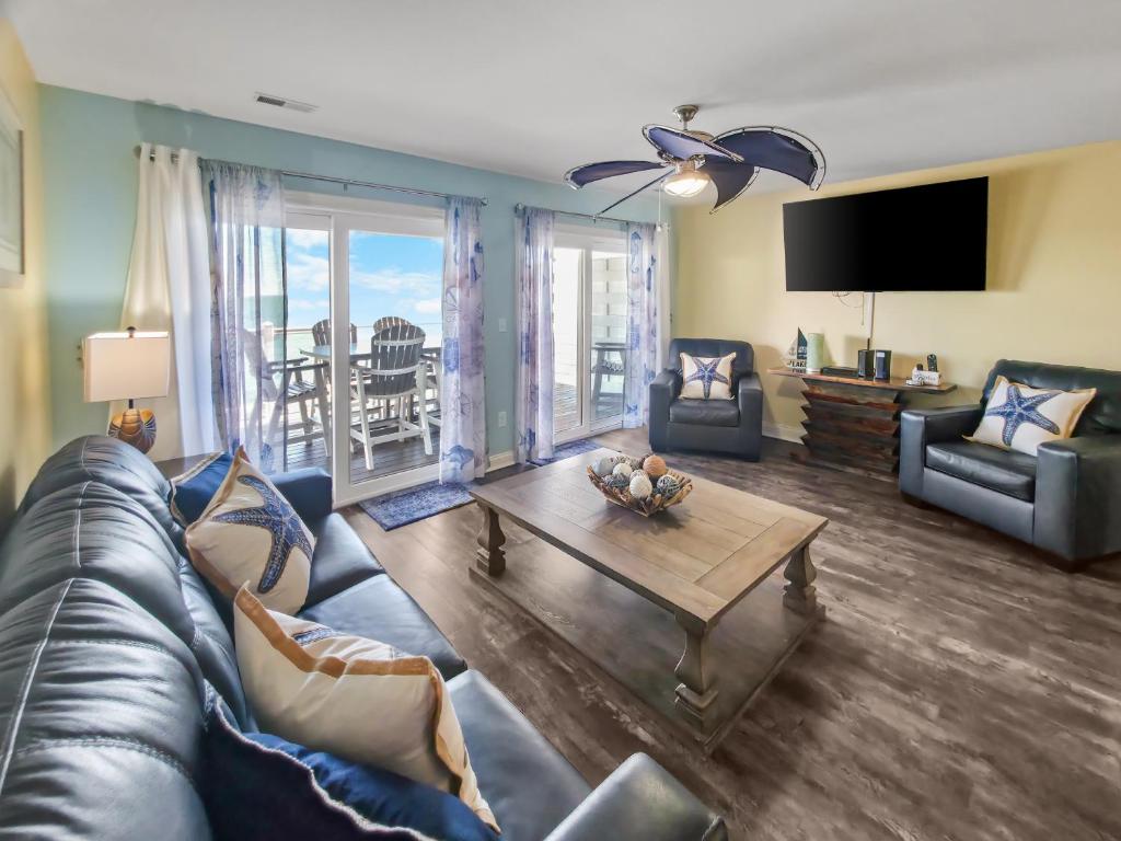 a living room with a couch and a table at Put-in-Bay Waterfront Condo #207 in Put-in-Bay
