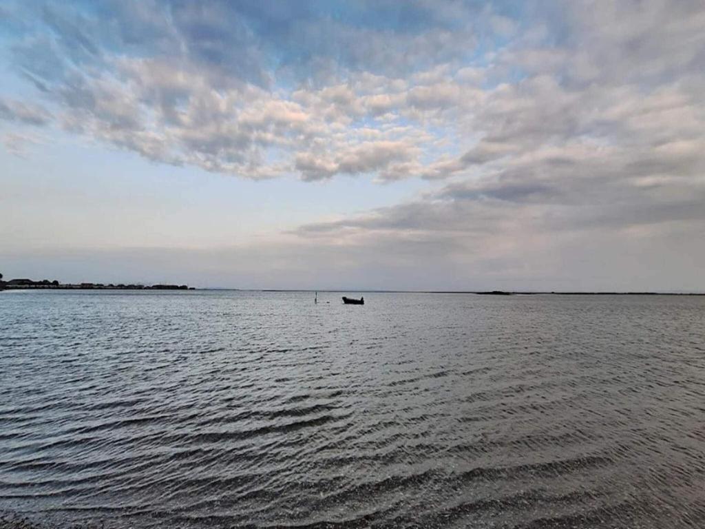 a boat in the middle of a large body of water at Bogense Ferieboliger 500 m til kysten in Bogense
