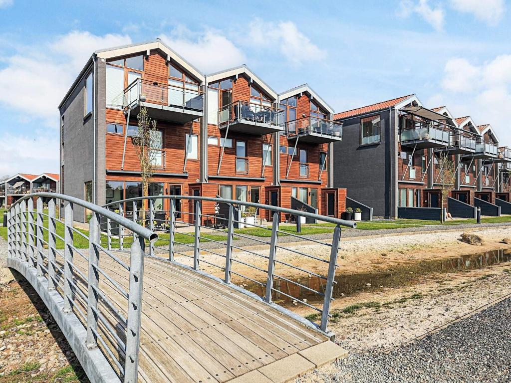 a wooden boardwalk in front of a building at 4 person holiday home in Bogense-By Traum in Bogense