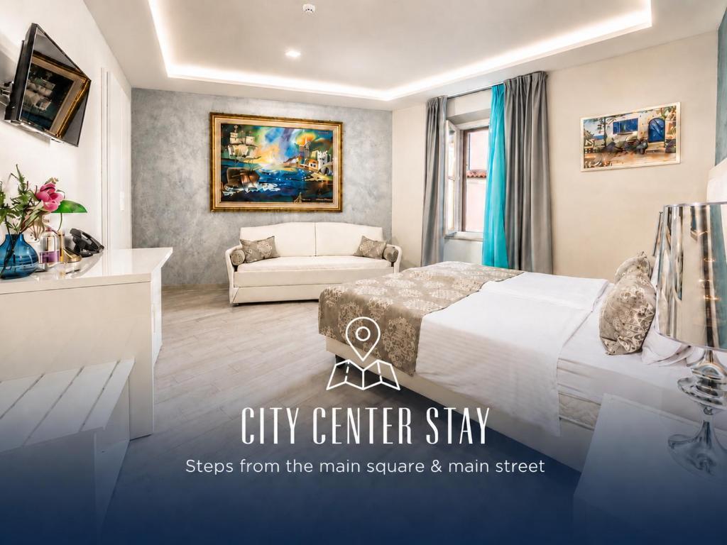 a city center stay room with a bed and a couch at Boutique Hotel Melissa in Poreč
