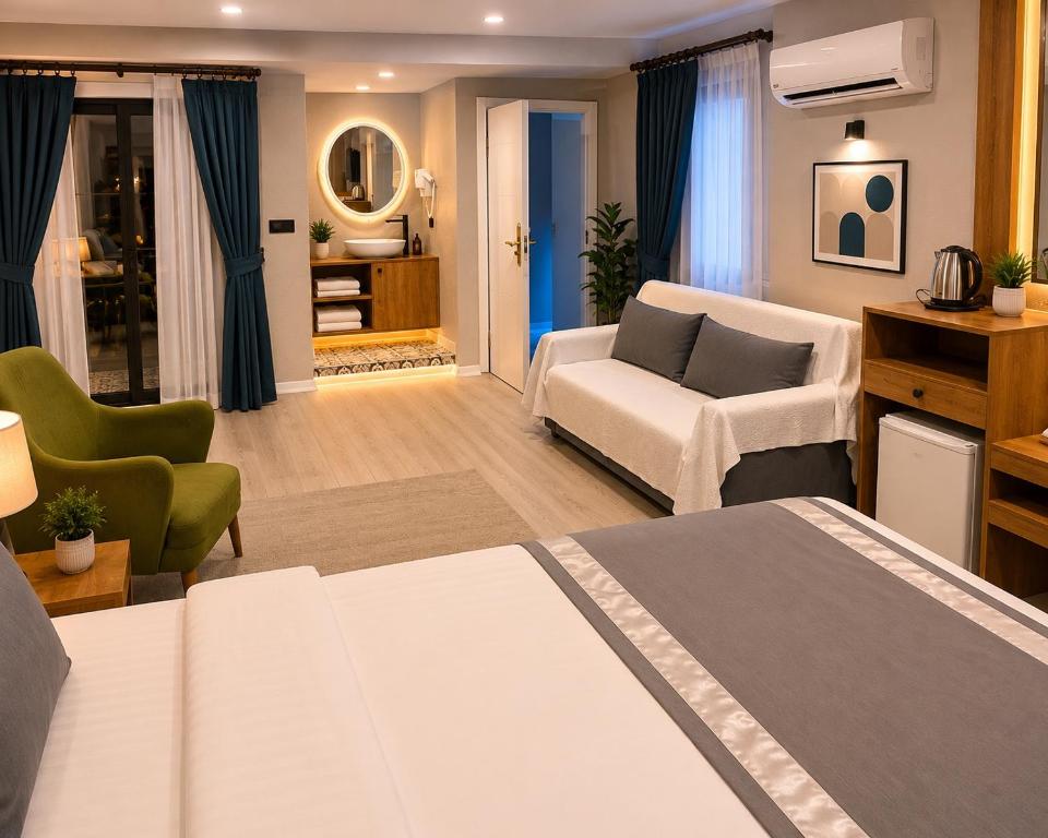 a room with a bed and a couch and a chair at Hotel Mara İstanbul in Istanbul