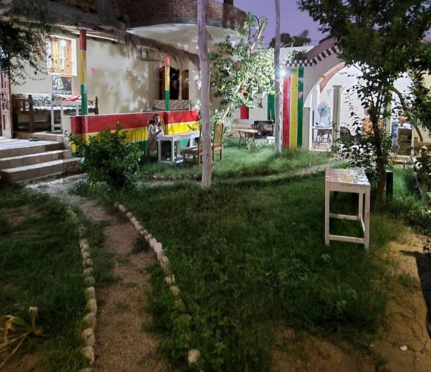 a yard with a house with a colorful yard sidx sidx sidx at Aisha Guest House And Restaurant in Al Aqālitah